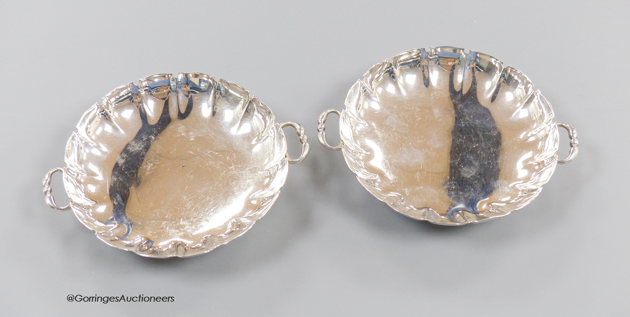A pair of 1930's silver two handled shallow dishes, Goldsmiths & Silversmiths Co Ltd, London, 1937, 14.2cm, 8.5oz.